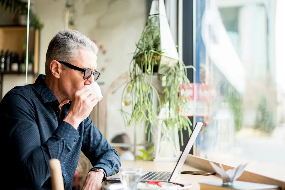 business man drinking coffee determining how much his business is worth