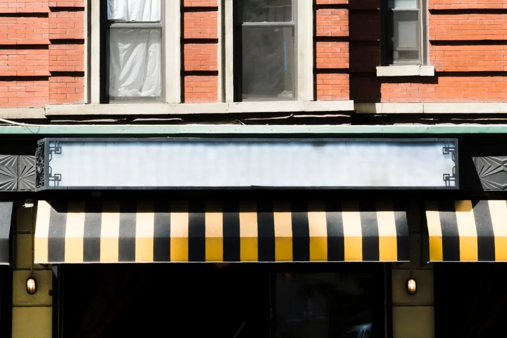 a building with a black and yellow awning