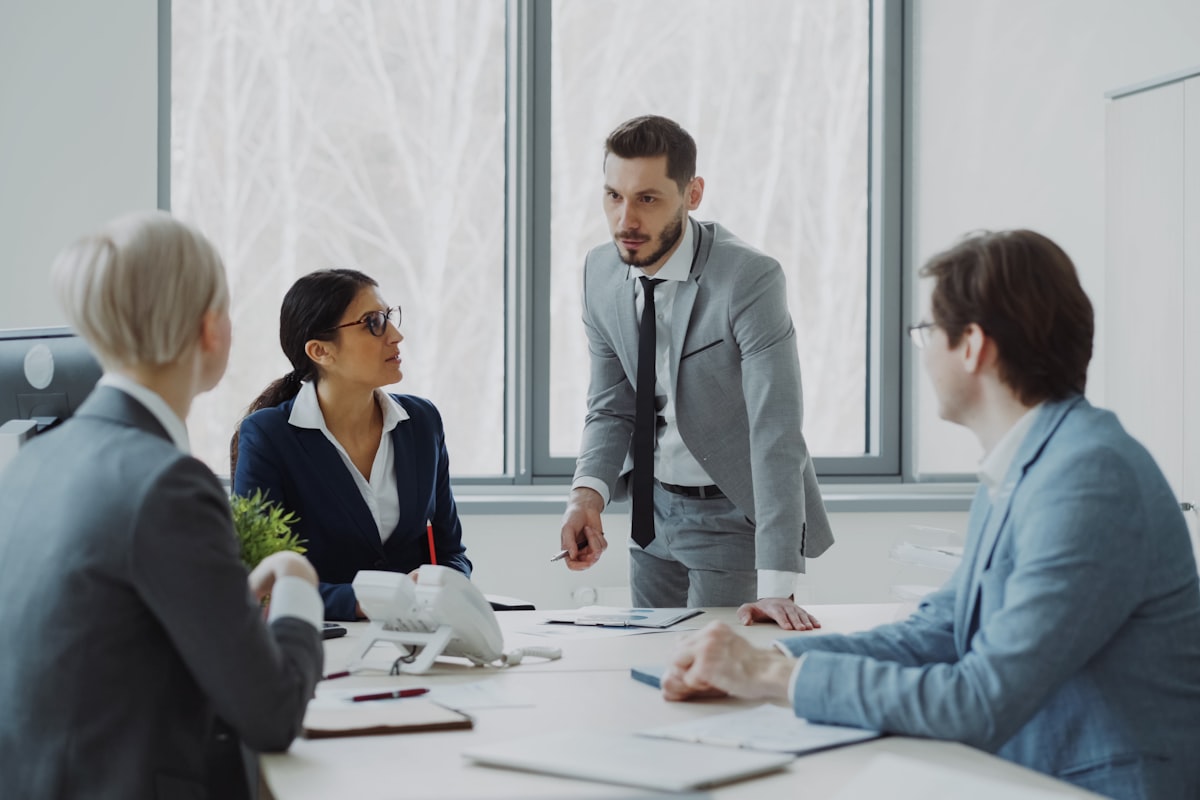 Business professionals meeting around a conference table in a bright office