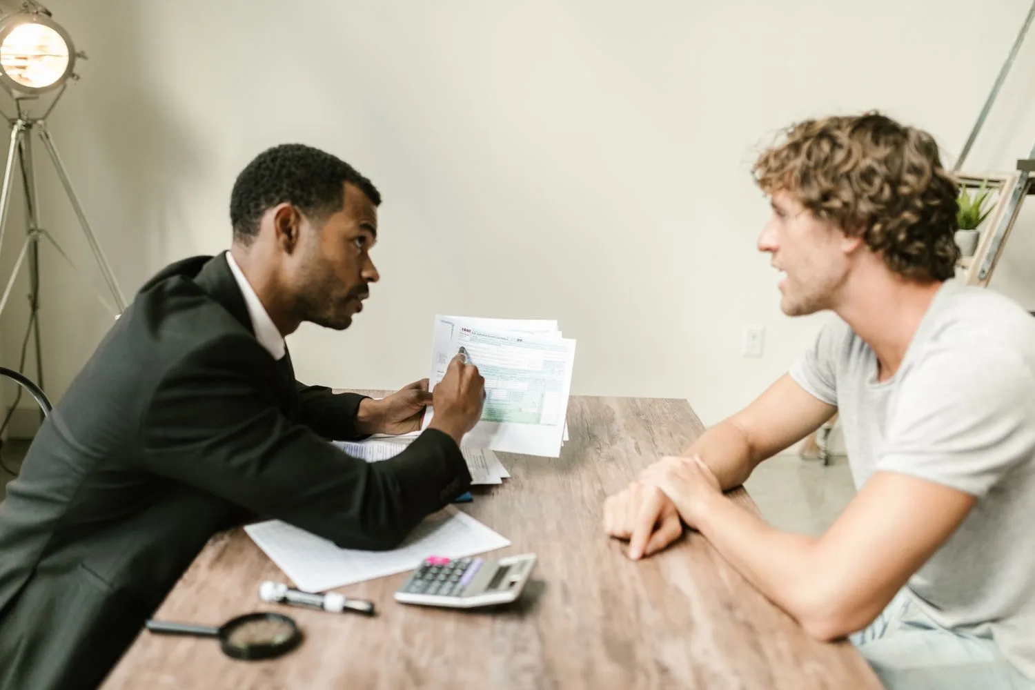 Advisor explaining business valuation to an owner Advisor explaining business valuation methods to a small business owner