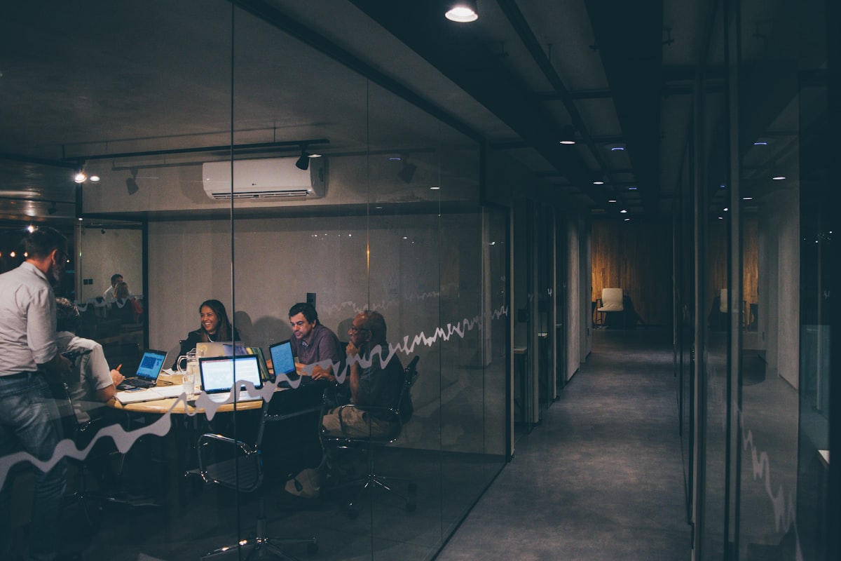 Professionals comparing business figures around a table in a bright modern office