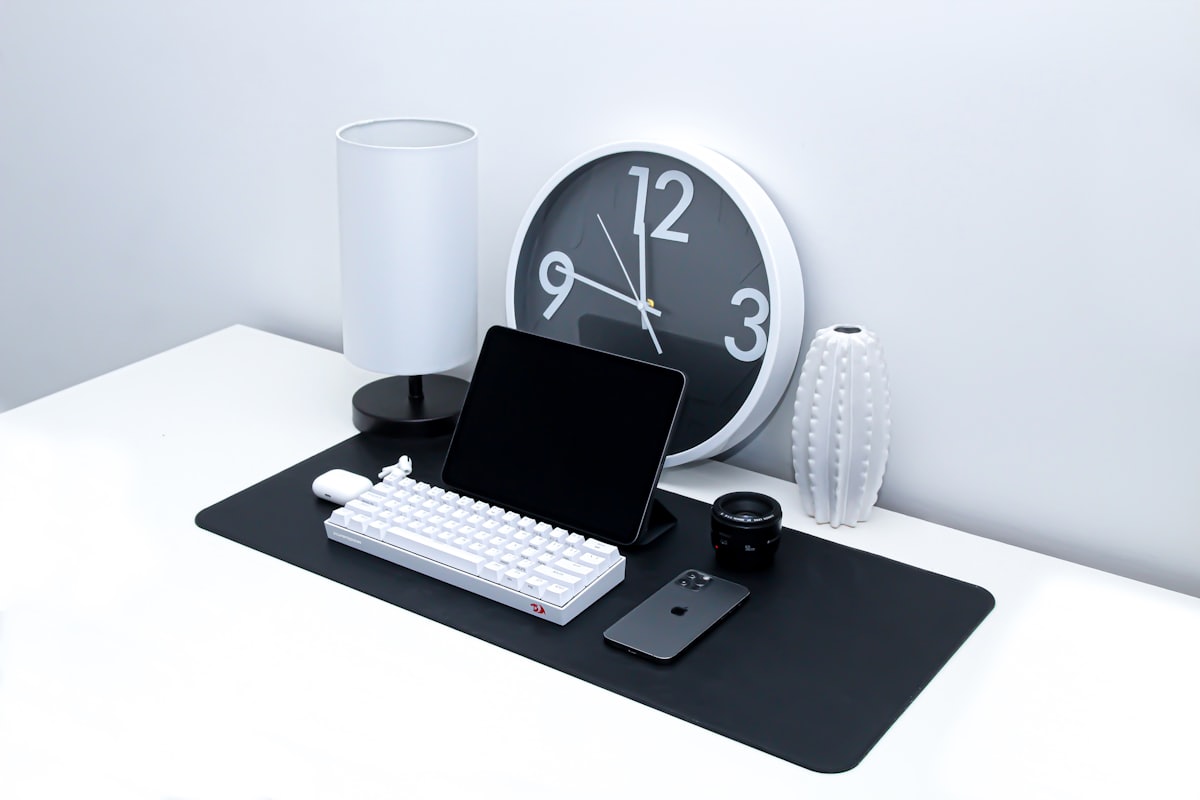 Tablet and keyboard on a desk used to review monthly contracted income