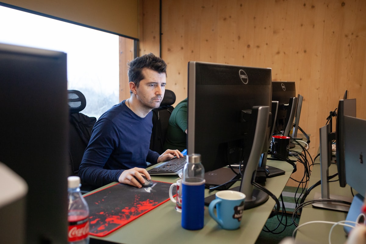 Business owner at a desk reviewing figures on a computer to work out what the business is worth