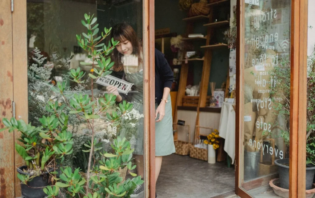 Small business owner opening her shop, wondering what the business is worth