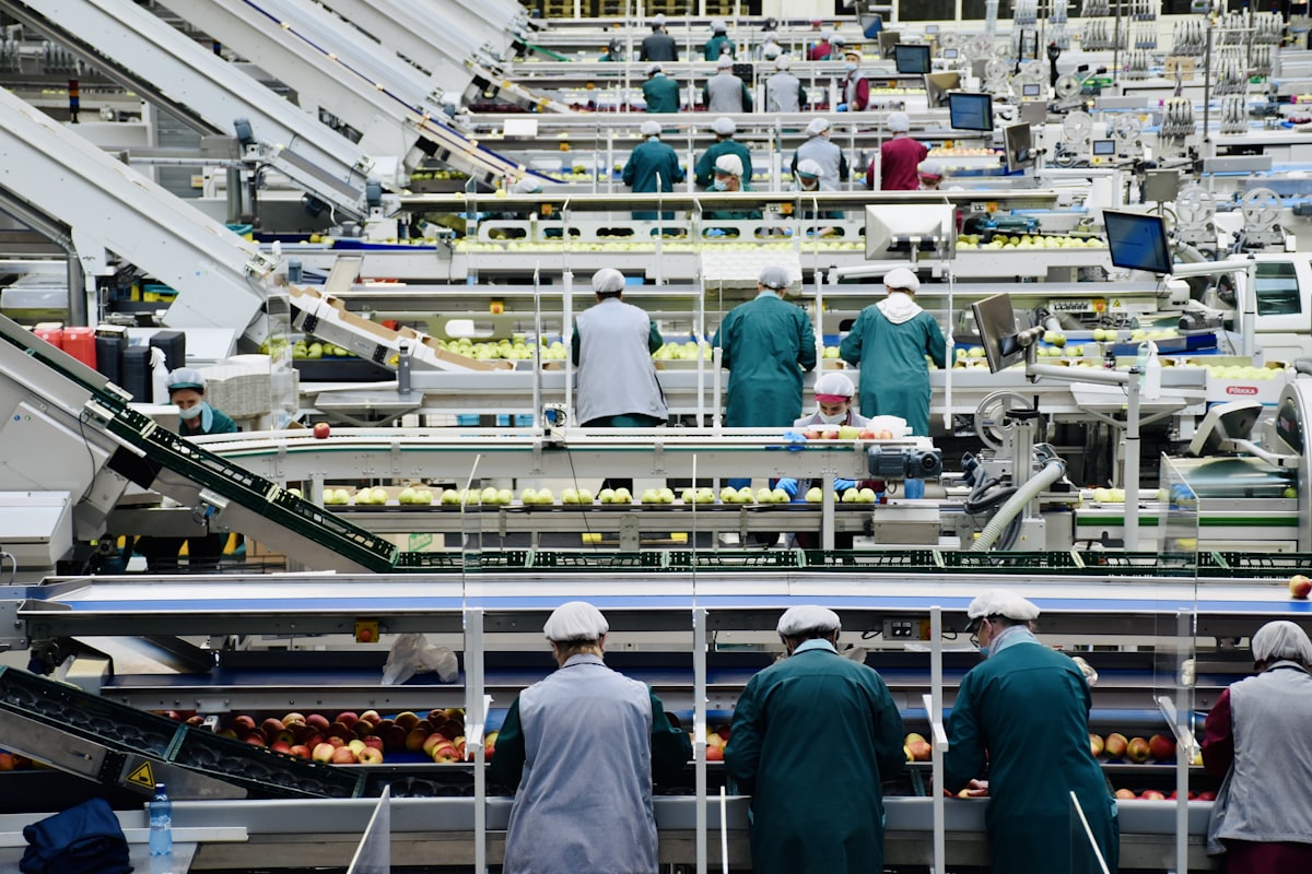 Manufacturing team on a factory floor, illustrating how valuation multiples differ by industry