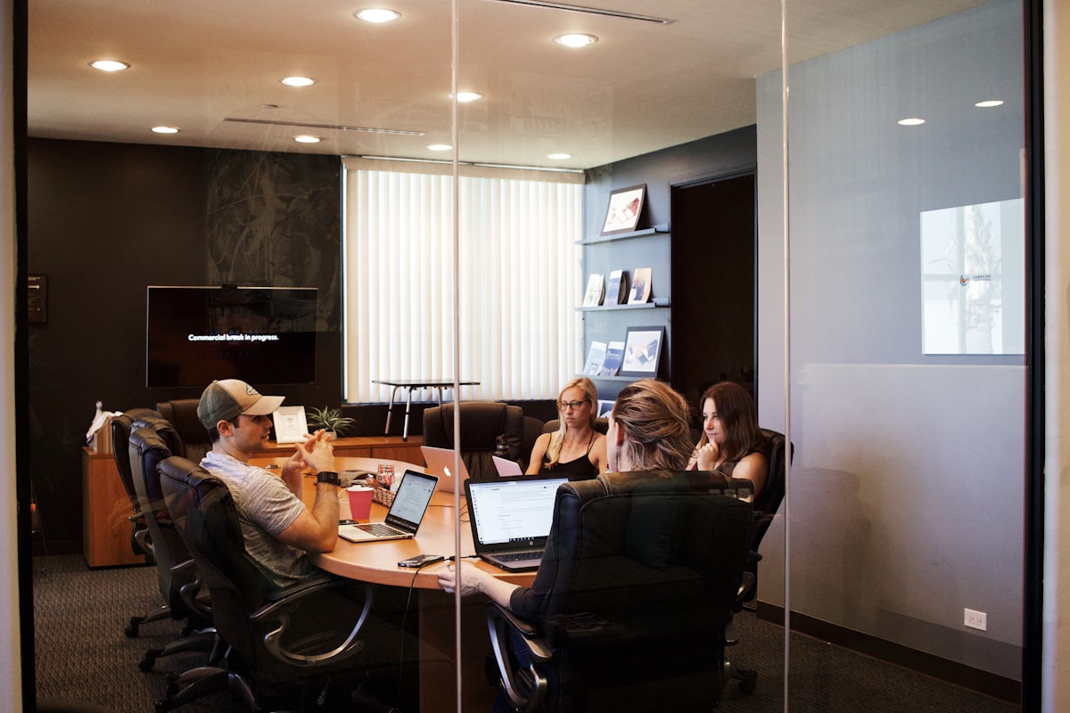 When the money actually lands Colleagues reviewing deal terms on a laptop in a bright meeting room