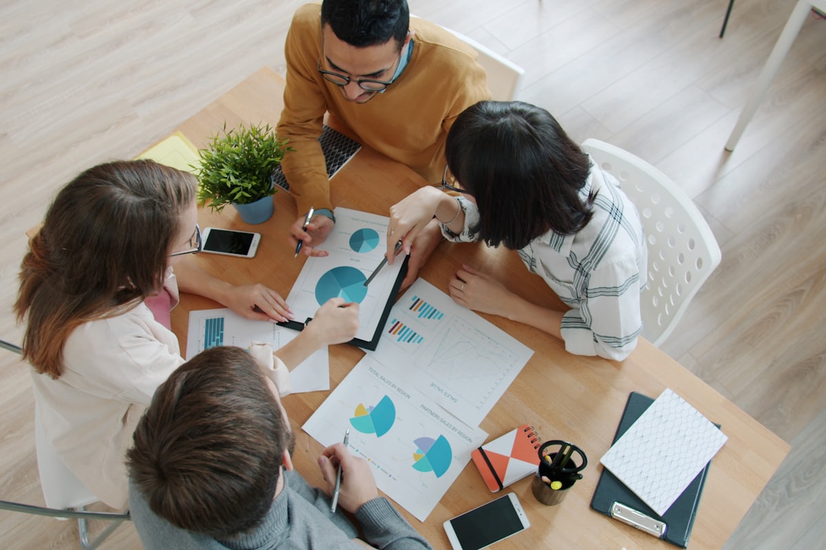 Business valuator analyzing company financial statements in a modern office