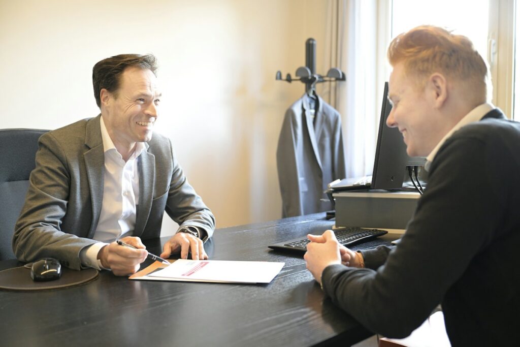 Business advisor and owner reviewing documents together across a desk