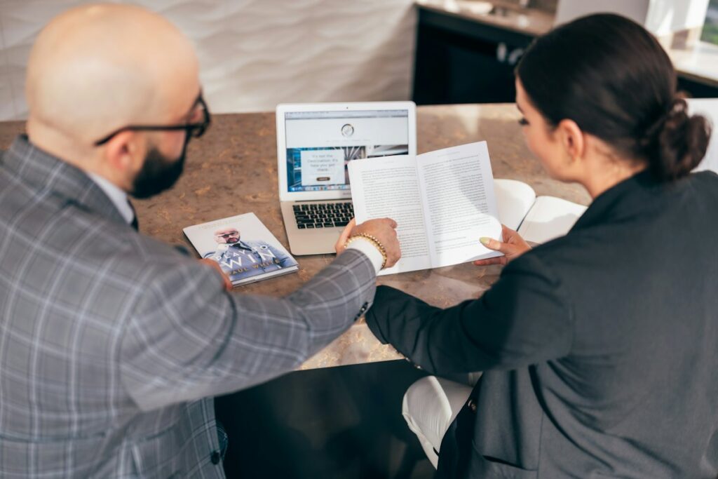 Advisor and business owner reviewing financial documents together